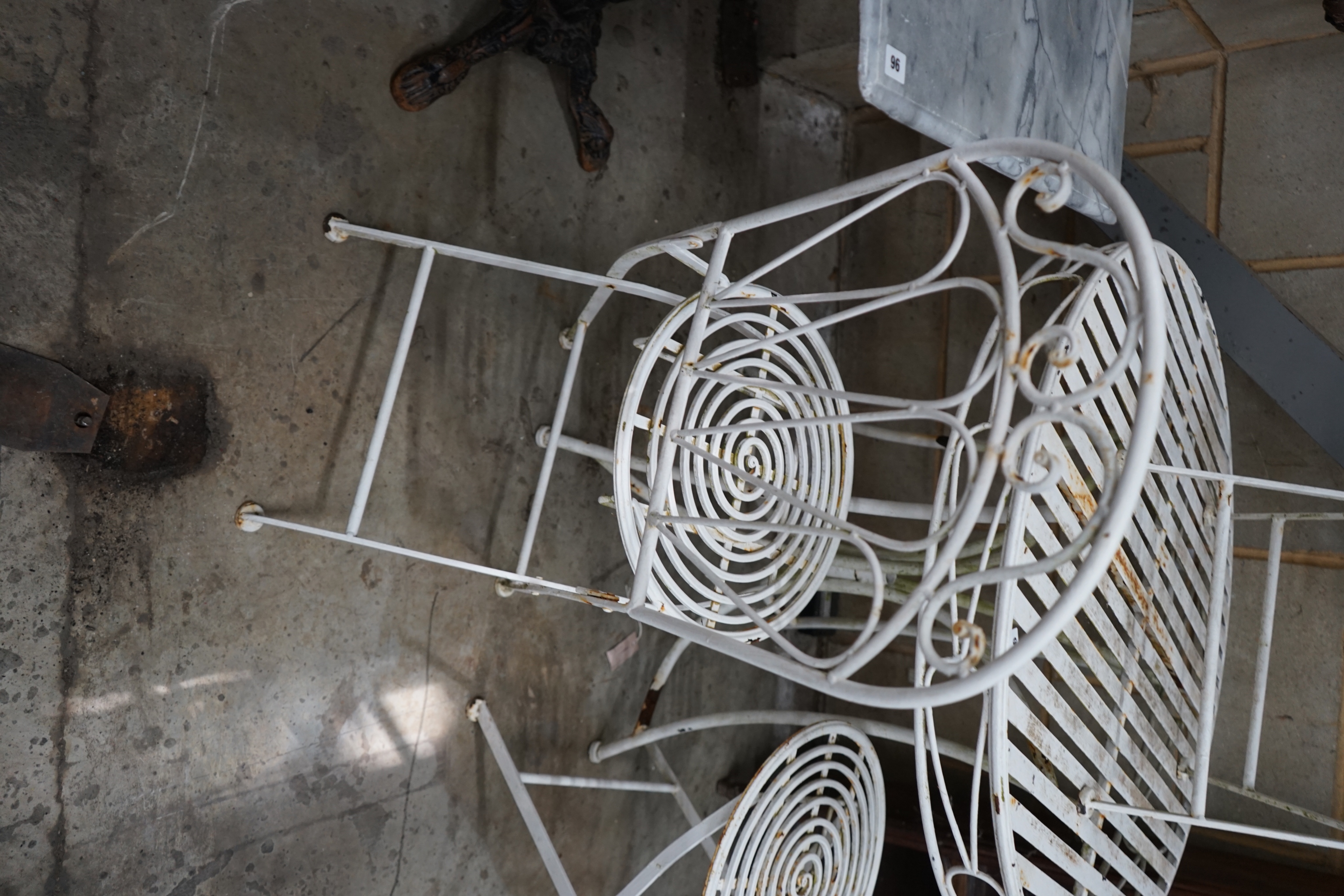 A circular metal garden table and three folding chairs, table diameter 90cm height 76cm